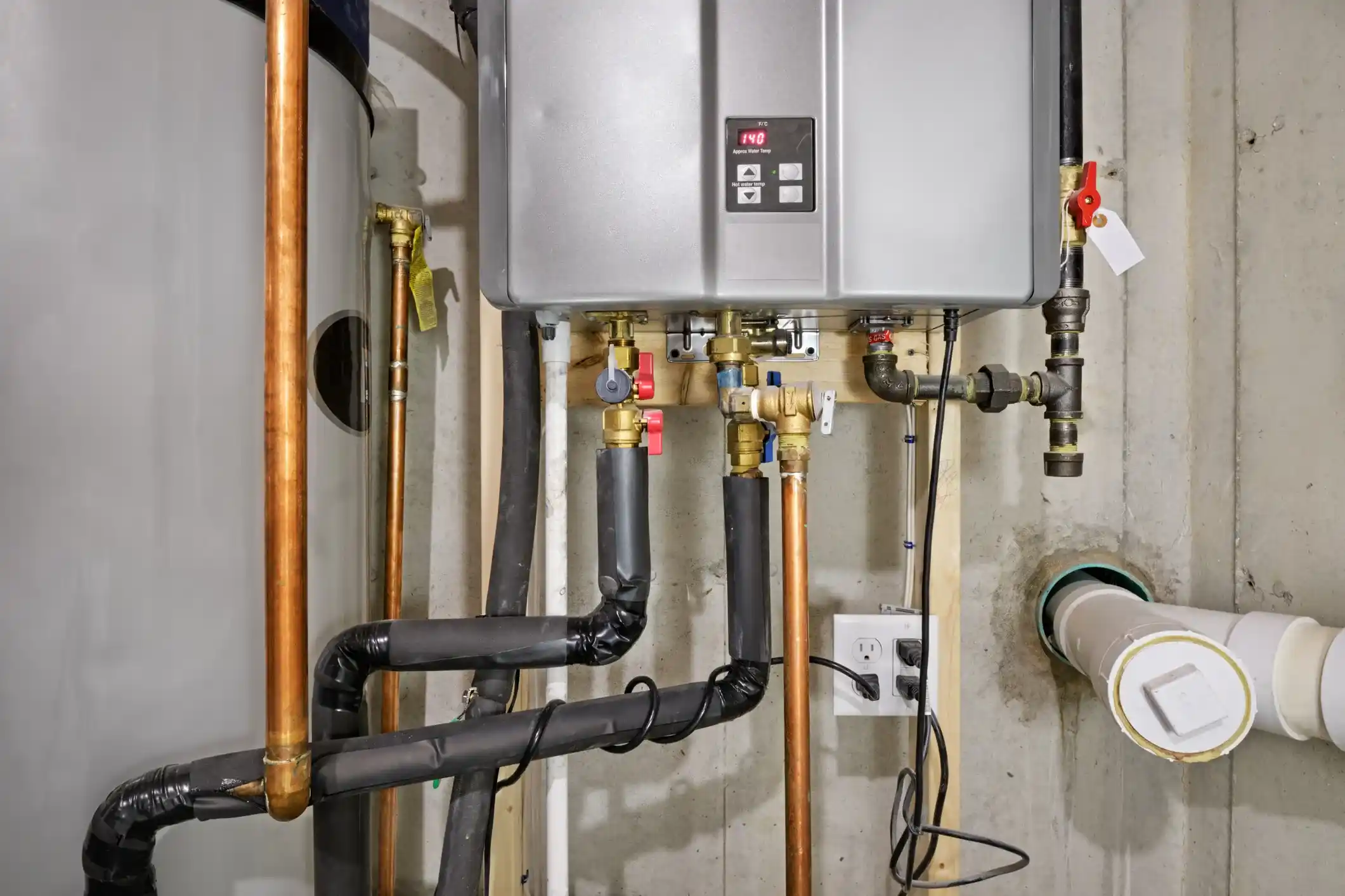 Staggs Plumbing technician servicing a water heater in North Texas